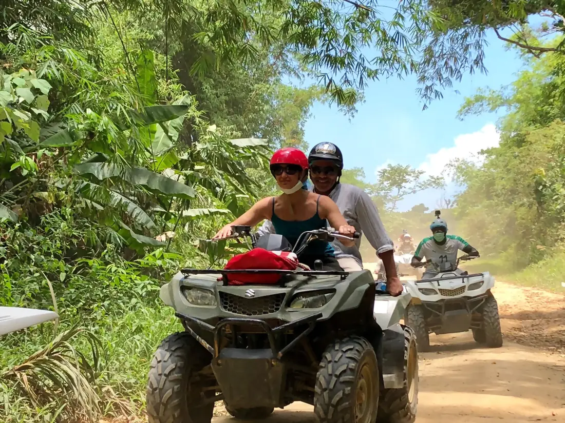 Couple riding quads on a dirt track in the hills of Koh Samui